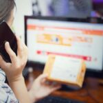 Woman multitasking with phone and online shopping